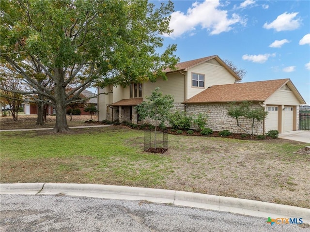 view of front facade with a front lawn and a garage