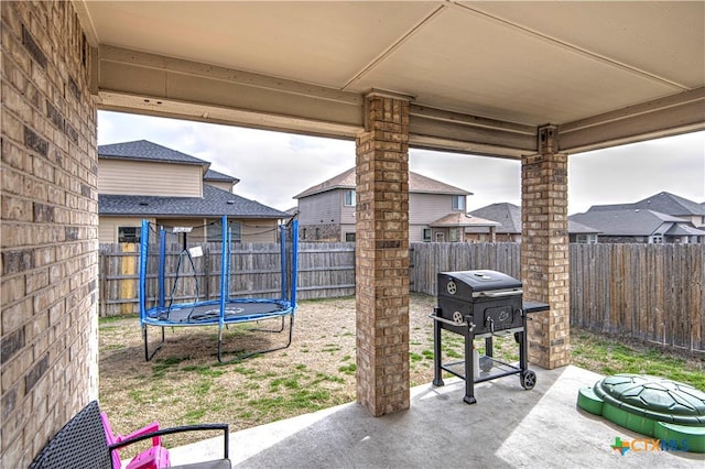 view of patio featuring area for grilling and a trampoline