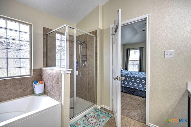 bathroom with vanity, separate shower and tub, tile patterned flooring, and a textured ceiling