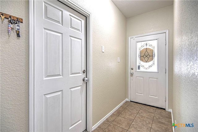 entryway with light tile patterned flooring