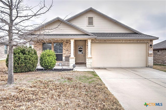 view of front of property featuring a garage and covered porch