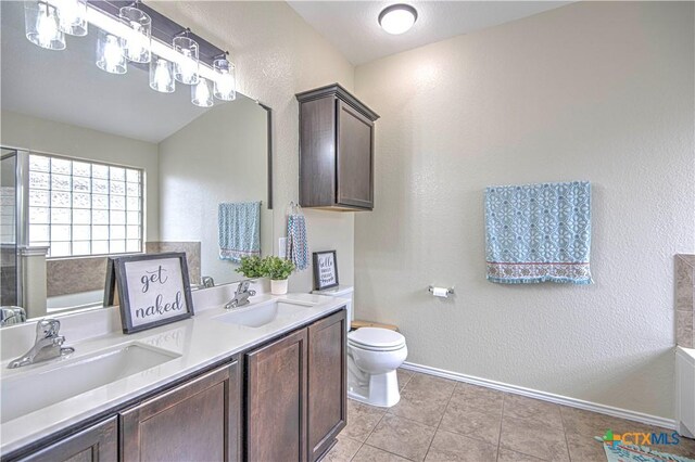 kitchen featuring pendant lighting, sink, stainless steel dishwasher, and dark brown cabinetry