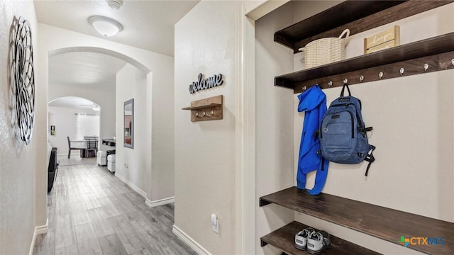 234 Wild Plum, San Marcos, TX 78666 - mudroom with arched walkways, baseboards, and wood finished floors