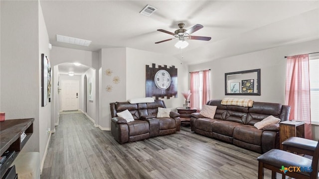234 Wild Plum, San Marcos, TX 78666 - living room featuring arched walkways, wood finished floors, ceiling fan, and baseboards