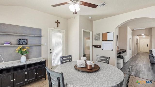 234 Wild Plum, San Marcos, TX 78666 - dining area with arched walkways, ceiling fan, light tile patterned flooring, and vaulted ceiling