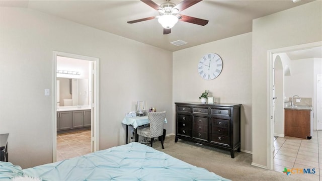 234 Wild Plum, San Marcos, TX 78666 - carpeted bedroom with ensuite bath, baseboards, arched walkways, a sink, and ceiling fan