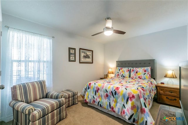 bedroom with ceiling fan and light colored carpet