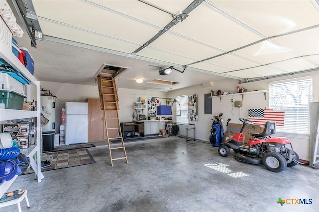 garage featuring electric water heater, white refrigerator, electric panel, and a garage door opener