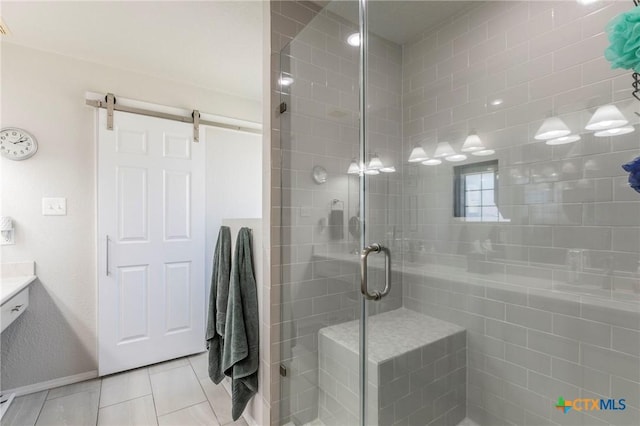 bathroom featuring tile patterned flooring, vanity, and walk in shower