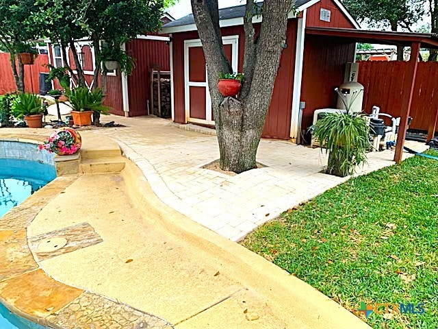exterior space featuring a patio and a storage shed