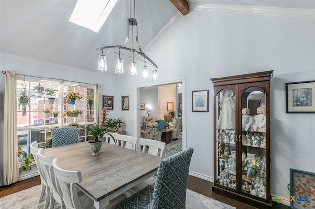 dining space featuring crown molding, a skylight, and dark hardwood / wood-style floors