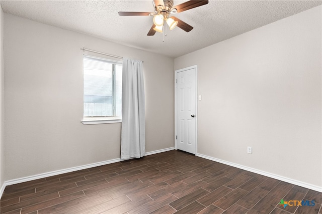 empty room featuring ceiling fan and a textured ceiling