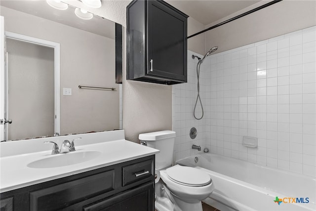 full bathroom featuring bathing tub / shower combination, vanity, and toilet