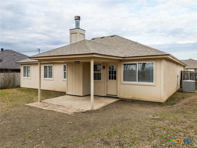 back of property with a yard, a patio, and central AC