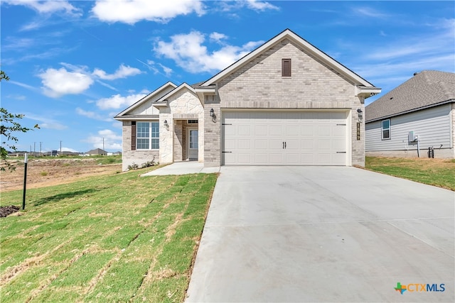 view of front of house with a garage and a front yard