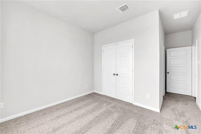 unfurnished bedroom with a closet and carpet flooring