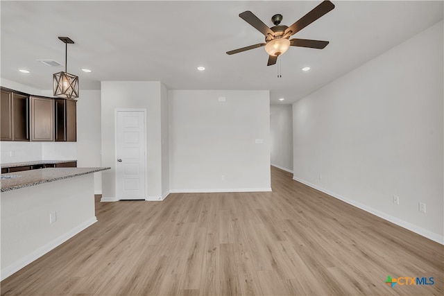 unfurnished living room with ceiling fan and light hardwood / wood-style floors