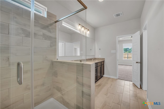 bathroom featuring hardwood / wood-style floors, vanity, and an enclosed shower