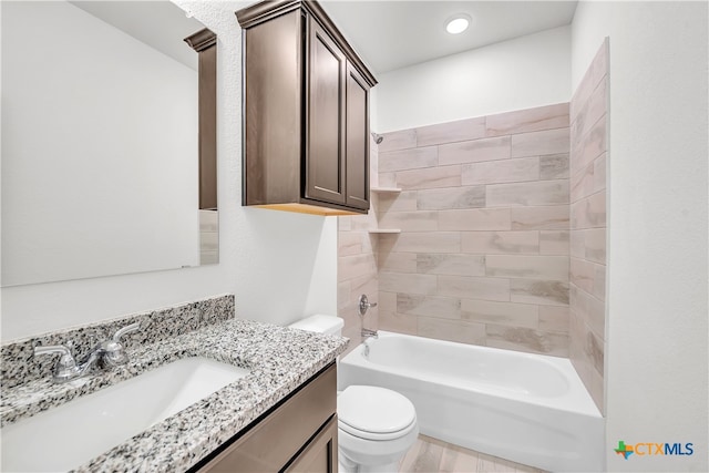 full bathroom with toilet, vanity, and tiled shower / bath