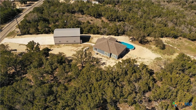 birds eye view of property with a forest view