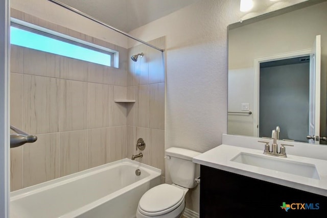 full bathroom featuring vanity, toilet, and tiled shower / bath combo