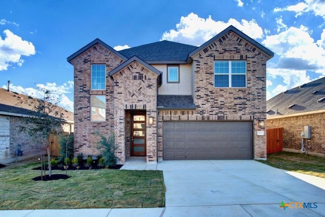 view of front of home with a garage and a front yard