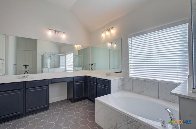 bathroom featuring tile patterned flooring, vanity, separate shower and tub, and lofted ceiling