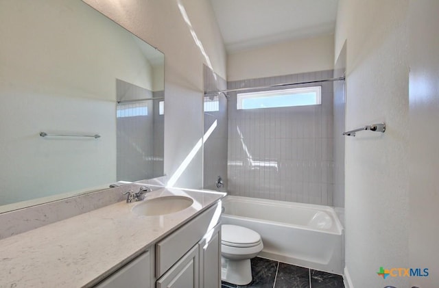 full bathroom with toilet, vanity, and tiled shower / bath