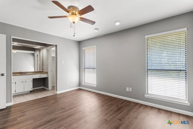 12103 Wycliff Ln, Austin, TX 78727 - unfurnished bedroom featuring light wood finished floors, ensuite bath, and ceiling fan