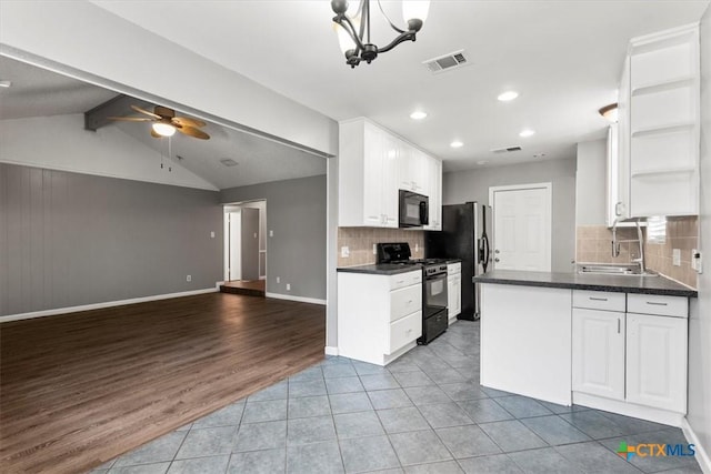 12103 Wycliff Ln, Austin, TX 78727 - kitchen featuring black appliances, dark countertops, open floor plan, open shelves, and white cabinets