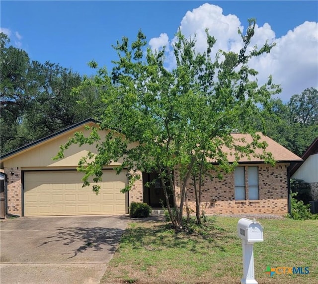 12103 Wycliff Ln, Austin, TX 78727 - view of front of property featuring brick siding, driveway, a garage, and a front yard