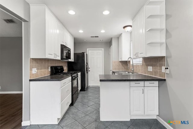 12103 Wycliff Ln, Austin, TX 78727 - kitchen with black appliances, open shelves, white cabinetry, a peninsula, and dark countertops