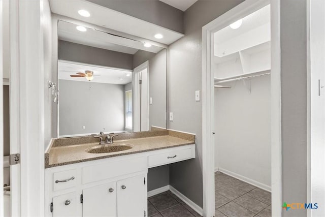 12103 Wycliff Ln, Austin, TX 78727 - bathroom with tile patterned flooring, vanity, a walk in closet, ceiling fan, and recessed lighting
