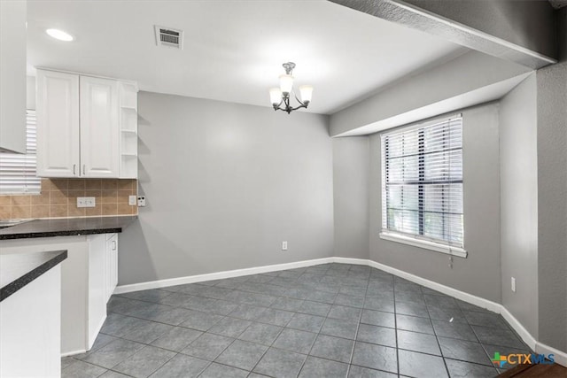 12103 Wycliff Ln, Austin, TX 78727 - unfurnished dining area with tile patterned floors, a chandelier, and recessed lighting