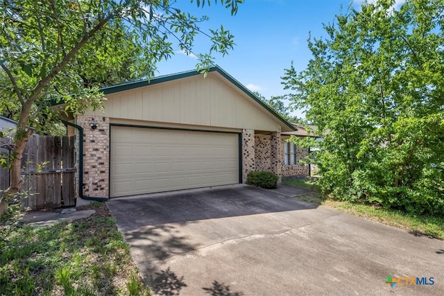 12103 Wycliff Ln, Austin, TX 78727 - ranch-style house with brick siding, concrete driveway, and an attached garage