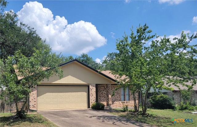 12103 Wycliff Ln, Austin, TX 78727 - view of front of house featuring brick siding, a garage, and concrete driveway