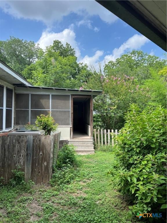 310 Smith Ln Unit A, San Marcos, TX 78666 - view of home's exterior featuring a sunroom
