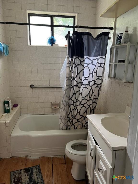 310 Smith Ln Unit A, San Marcos, TX 78666 - bathroom featuring wood finished floors, vanity, shower / bath combo with shower curtain, and toilet