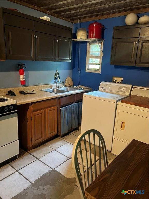 310 Smith Ln Unit A, San Marcos, TX 78666 - kitchen featuring washing machine and dryer, white range, a sink, light countertops, and light tile patterned floors