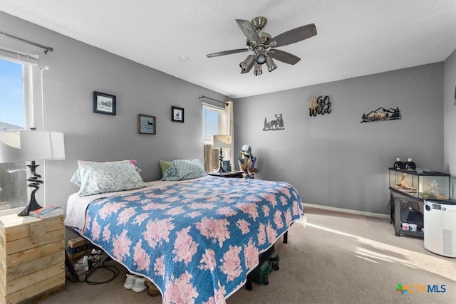 bedroom with carpet floors, baseboards, and a ceiling fan