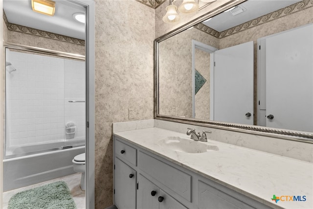 full bathroom with  shower combination, vanity, and toilet