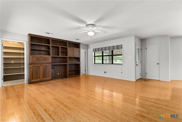 unfurnished living room with light hardwood / wood-style flooring and ceiling fan