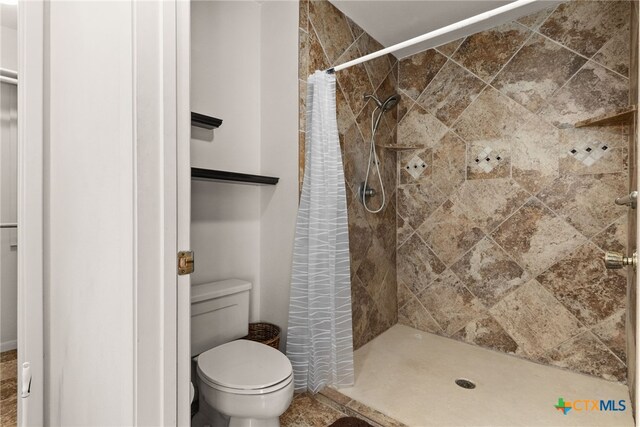 bathroom with walk in shower and toilet