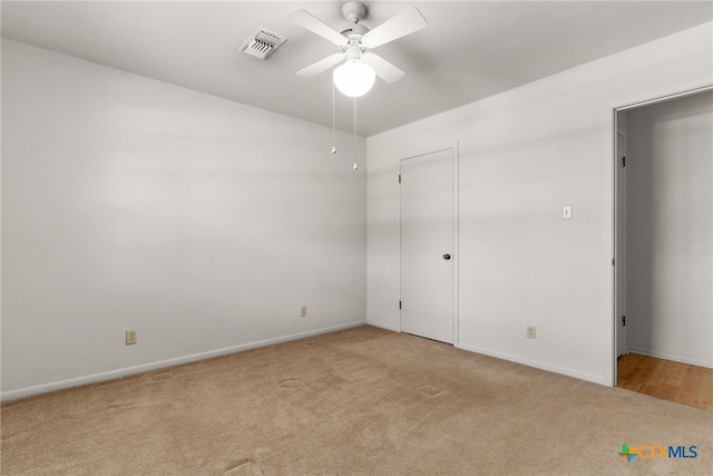 unfurnished bedroom featuring ceiling fan and light carpet