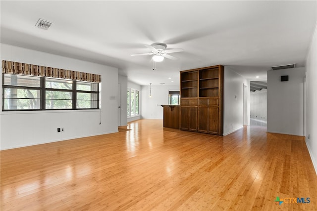 unfurnished living room with ceiling fan and light hardwood / wood-style floors