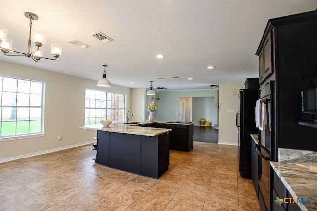 4113 Fm 1670, Belton, TX 76513 - kitchen with a large island, a chandelier, black appliances, recessed lighting, and dark cabinetry