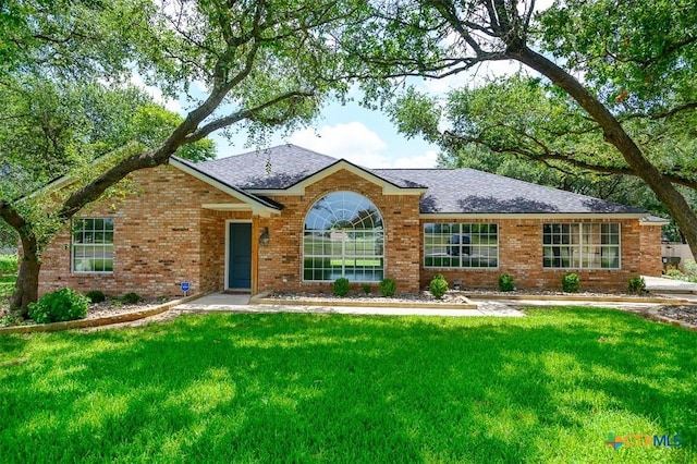 4113 Fm 1670, Belton, TX 76513 - view of front facade featuring a front yard, roof with shingles, and brick siding