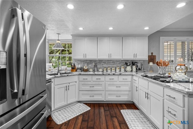 2203 Antelope Trl, Harker Heights, TX 76548 - kitchen with stainless steel fridge, black cooktop, a textured ceiling, a peninsula, and white cabinets