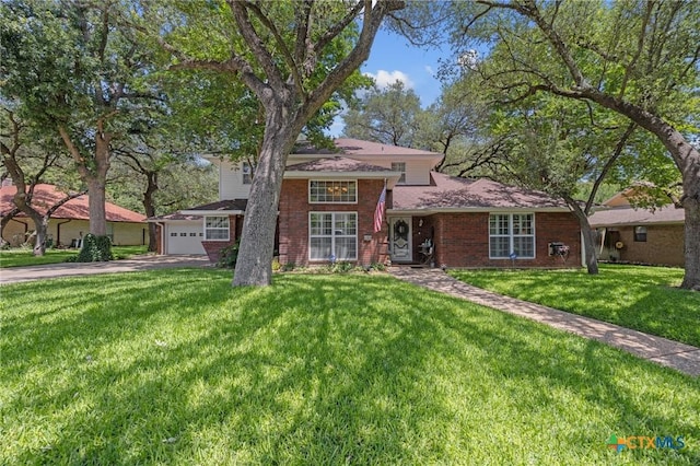 2203 Antelope Trl, Harker Heights, TX 76548 - split level home featuring driveway, a front yard, brick siding, and a garage