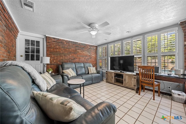2203 Antelope Trl, Harker Heights, TX 76548 - living room featuring brick wall, a ceiling fan, a textured ceiling, and light tile patterned floors